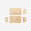 Five flat wooden panels of various sizes and ten screws are arranged on a white background, suggesting pieces for assembly, possibly for a small table or shelf.