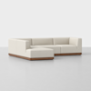A modern L-shaped sectional sofa with light beige upholstery and a wooden base, set against a plain white background.