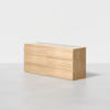 A modern, light wood dresser with six drawers, featuring a minimalist design and no visible handles, is placed on a smooth, light-colored floor against a plain white background.