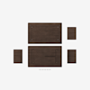 A top-down view of disassembled dark brown wooden furniture pieces and screws arranged neatly on a white background.