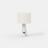 A modern table lamp with a white cylindrical fabric shade and a smooth, rounded marble base featuring gray veining and a small black circular accent near the bottom, set against a plain white background.
