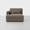 A modern, brown upholstered chaise lounge with a single left armrest and a matching cylindrical pillow, positioned against a plain white background.
