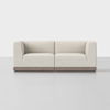 A modern, minimalist beige two-seat sofa with thick cushions and wooden base, set against a plain white background.