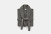 A neatly folded dark gray bathrobe with a shawl collar and a matching belt tied at the front, displayed against a plain white background.