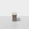Minimalist wooden table with a rectangular top and solid central base, photographed against a plain white background.