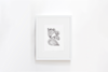 A framed abstract black and white artwork hangs on a plain white wall. The drawing features swirling, organic shapes and curves, giving a simple and minimalist appearance.
