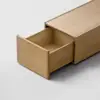 A minimal wooden drawer is partially open, revealing its empty interior. The drawer features smooth, light wood and a simple, modern design, photographed against a plain light background.