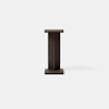 A small, dark brown wooden side table with a square top and base, featuring a simple and modern minimalist design, set against a plain light gray background.