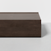 A rectangular, dark wood coffee table with clean lines and a solid base, set against a plain white background.
