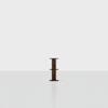 A small, dark wooden two-tiered shelf stands alone in the center of an empty, white room with a smooth floor.