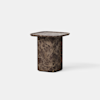 A small, modern side table made of dark brown marble with light veining, featuring a thick, rounded-column base and a square top with softly curved edges, set against a plain white background.