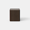 A modern, dark brown wooden nightstand with a single drawer partially open, set against a plain white background.