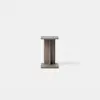 A small, minimalist wooden side table with a rectangular top and base, joined by a central vertical panel, photographed against a plain white background.