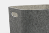 A close-up of a grey felt storage bin with a rectangular cut-out handle on one side, set against a plain white background.