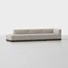 A modern, light beige sectional sofa with clean lines and a low, dark wooden base, placed in a minimalist, empty room with a light grey floor and white background.