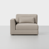 A modern, light beige upholstered loveseat with a left armrest and a matching rectangular cushion, set against a plain white background.
