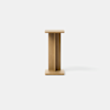 A minimalist wooden side table with a square top, central vertical support, and square base, photographed against a plain white background.
