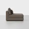 A modern chaise lounge with a low backrest and two cushions, upholstered in brown fabric, set against a plain white background.