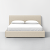 A modern beige upholstered bed with a low headboard, dressed in white bedding and two pillows, set against a plain white wall on a light gray floor.