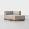A modern, light beige upholstered sectional sofa with a low wooden base and one armrest on the left side, positioned on a plain white background.