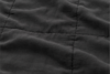 A close-up view of a dark gray quilted fabric with visible stitching forming square patterns and soft, slightly wrinkled texture.
