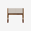A front view of a modern wooden bench with a light beige cushioned seat and backrest, set against a plain white background.