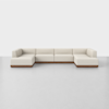 A large, modern, U-shaped sectional sofa with light beige upholstery and a wooden base, set on a light gray floor against a plain white background.
