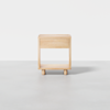 A minimalist wooden nightstand with a single drawer and open shelf, standing on four short cylindrical legs, shown against a plain white background.