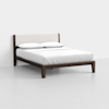 A modern bed with a dark wooden frame, beige upholstered headboard, white bedding, and two white pillows, set against a plain white wall and floor.