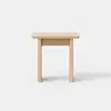 A small, light wood table with a simple rectangular top and four straight legs, set against a plain white background.