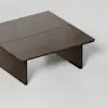 A dark brown wooden coffee table with a rectangular top and simple, clean lines, set against a light, plain background.