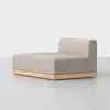 A modern, minimalist chaise lounge with light beige upholstery and a low, rectangular wooden base, set against a plain white background.