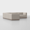 A modern, beige L-shaped sectional sofa with clean lines and a low back, set on a wooden base, positioned on a smooth light gray floor against a plain white background.