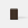 A modern, dark wood nightstand with a rectangular shape and an open base, featuring one drawer that is partially pulled out. The nightstand is set against a plain white background.