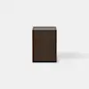 A modern, dark wood nightstand with a rectangular shape and an open base, featuring one drawer that is partially pulled out. The nightstand is set against a plain white background.