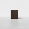 A dark brown, four-drawer wooden dresser stands alone on a smooth, light gray floor against a plain white background.
