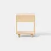 A minimalist wooden nightstand with a single drawer and an open lower shelf, standing on short cylindrical legs against a plain white background.