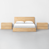 A minimalist bedroom set with a light wood bed frame and headboard, white bedding and pillows, and matching light wood nightstands on both sides, all against a plain white wall and gray floor.