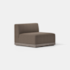 A modern armless accent chair with brown upholstery and a light wood base, set on a smooth, light-colored floor against a plain white background.