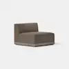 A modern armless accent chair with brown upholstery and a light wood base, set on a smooth, light-colored floor against a plain white background.