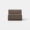 A modern armless brown upholstered loveseat with a low backrest and dark wooden base, placed on a light gray floor against a plain white background.