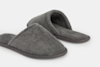 A pair of cozy, gray, open-back slippers made from soft, textured fabric, placed on a plain white background.