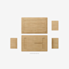 A flat lay of disassembled wooden furniture pieces and screws displayed on a white background, arranged neatly to show each part separately.