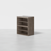 A wooden shelving unit with four open compartments, featuring a natural wood finish, standing on a smooth, light gray floor against a plain white background.