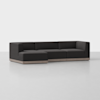 A modern, L-shaped sectional sofa with dark gray upholstery, low backrests, and a light wood base, set against a plain white background.
