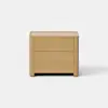 A minimalist wooden nightstand with two drawers, featuring a natural light wood finish and clean, rounded edges, stands against a plain white background.
