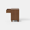 A wooden cabinet with a simple, boxy design stands on short cylindrical legs against a plain white background.