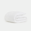 A neatly folded, white, quilted blanket or comforter is shown against a plain white background.