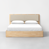 A minimalist wooden bed frame with a light beige upholstered headboard, white bedding, and two white pillows, set against a plain white wall and gray floor.