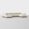 A modern, L-shaped sectional sofa with cream-colored upholstery and a wooden base, set on a plain white background.